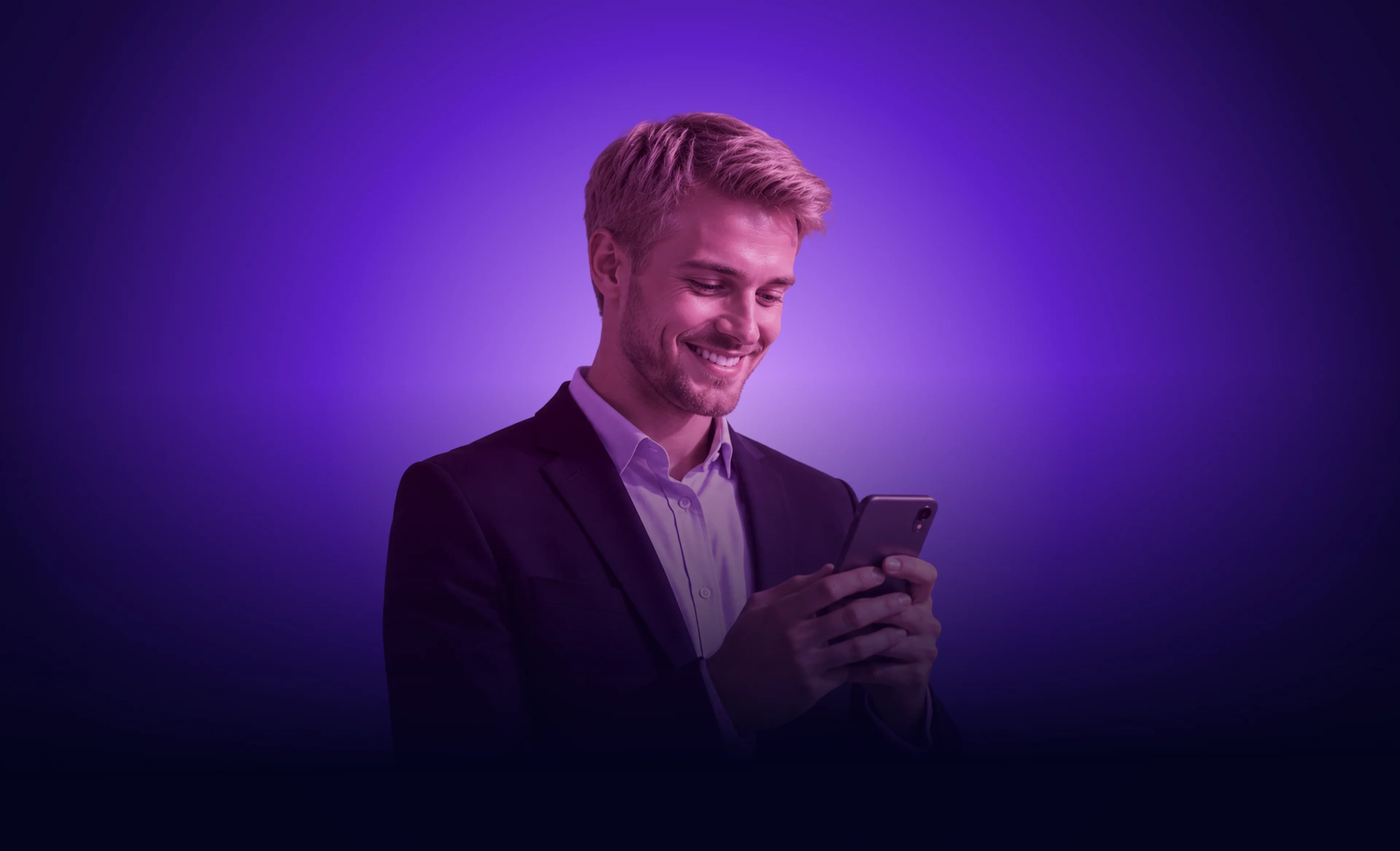 Mosolygó férfi mobiltelefonnal a kezében